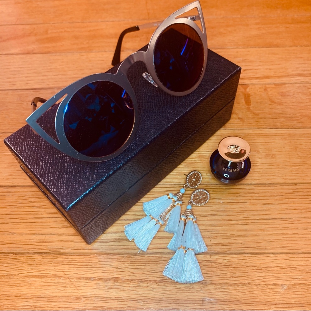Cat-wing, blue lens silver framed sunglasses